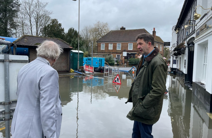 Gareth discussing the impacts of recent flooding in Chalfont St. Peter with local resident