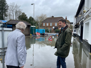 Gareth discussing the impacts of recent flooding in Chalfont St. Peter with local resident